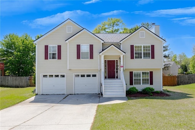 bi-level home with an attached garage, a chimney, concrete driveway, and fence
