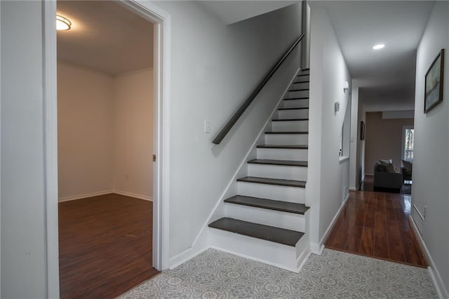 staircase with hardwood / wood-style flooring