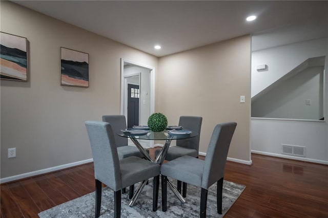 dining space with dark wood-type flooring