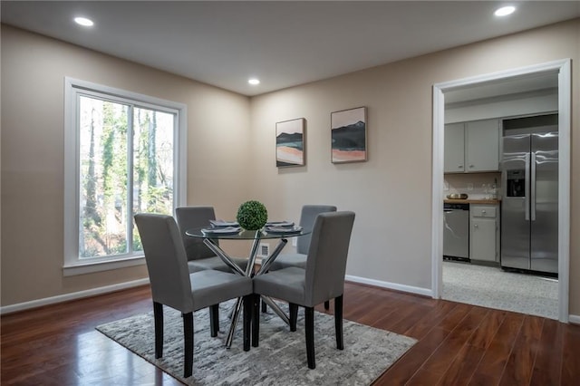 dining area with dark hardwood / wood-style floors