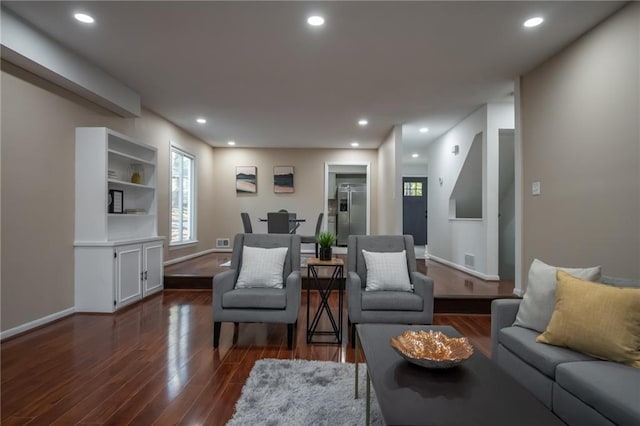 living room with dark hardwood / wood-style flooring