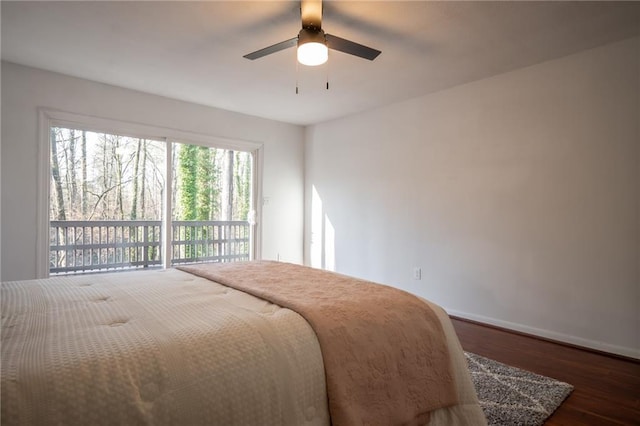 bedroom with dark hardwood / wood-style floors, access to exterior, and ceiling fan