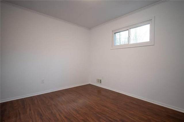 empty room with ornamental molding and dark hardwood / wood-style floors