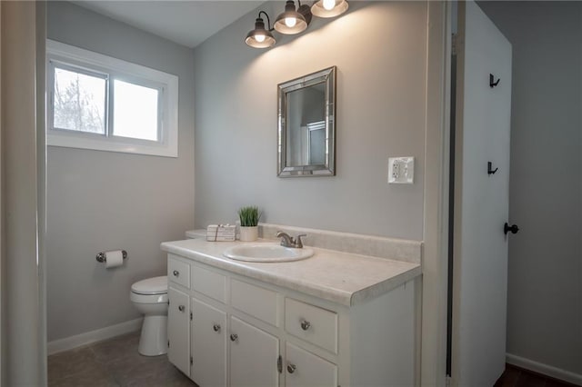 bathroom featuring tile patterned floors, vanity, and toilet