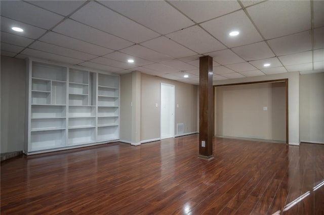 basement with dark hardwood / wood-style floors