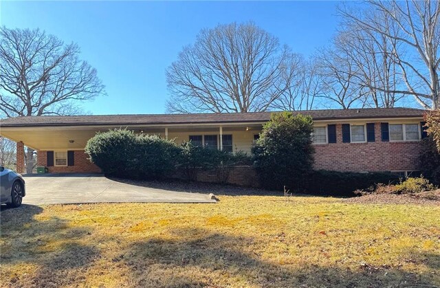 single story home with a front yard and a carport