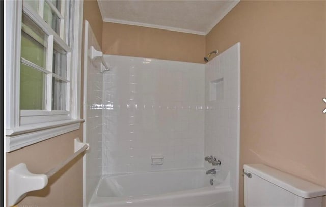 bathroom with crown molding, shower / bathing tub combination, and toilet