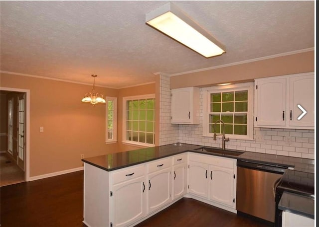 kitchen featuring dark countertops, dishwasher, a peninsula, and a sink