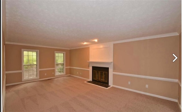 unfurnished living room featuring baseboards, a glass covered fireplace, ornamental molding, carpet, and a textured ceiling