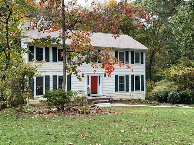 colonial inspired home with a front lawn