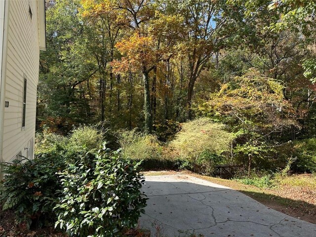 view of yard featuring a patio area and a view of trees