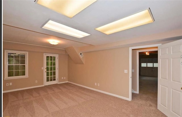 bonus room with light carpet and baseboards