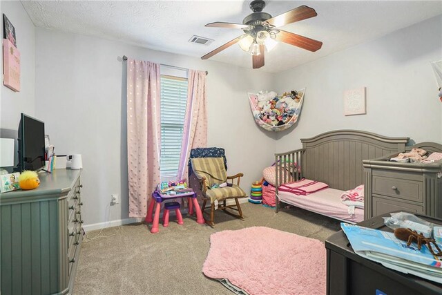 bedroom with light carpet, a textured ceiling, and ceiling fan