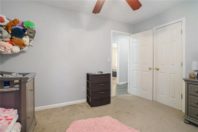 bedroom featuring ceiling fan and light carpet