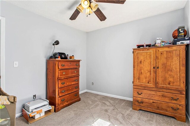 bedroom with light colored carpet, a tray ceiling, a closet, and ceiling fan