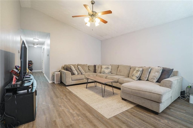 living room featuring lofted ceiling, hardwood / wood-style flooring, and ceiling fan