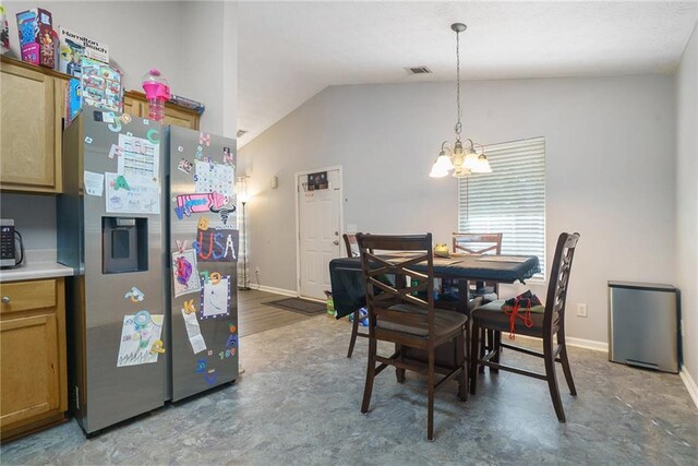 dining space with lofted ceiling, a chandelier, and wood-type flooring