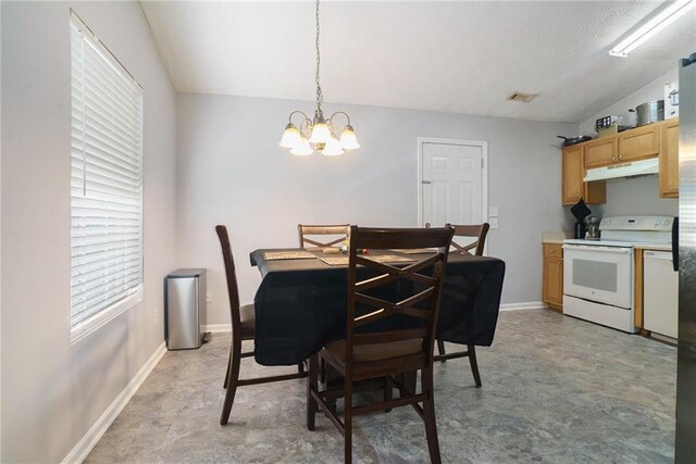 dining space with lofted ceiling and a notable chandelier