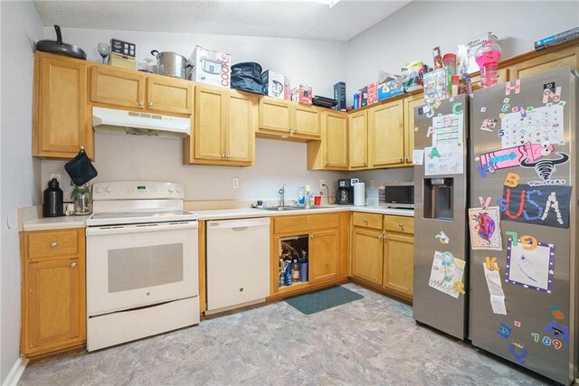 kitchen featuring sink, vaulted ceiling, and white appliances