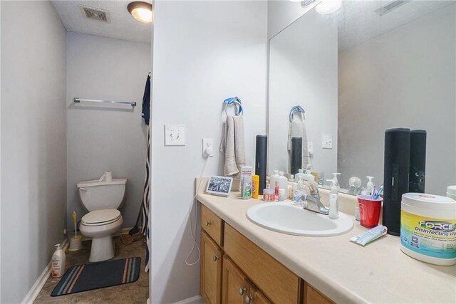 bathroom with vanity and toilet