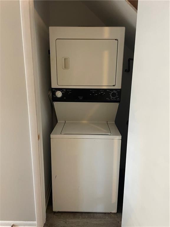 laundry area with stacked washer and clothes dryer