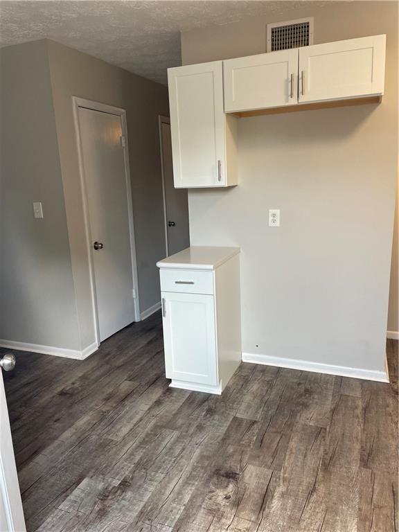 kitchen with white cabinetry and dark hardwood / wood-style flooring