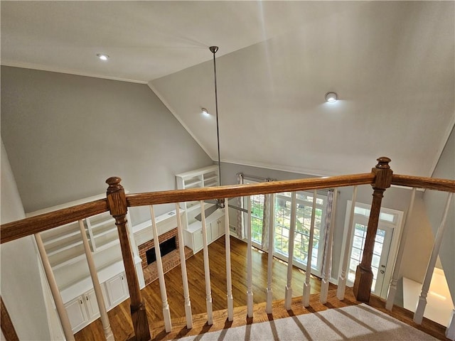 stairway featuring recessed lighting, lofted ceiling, crown molding, and wood finished floors