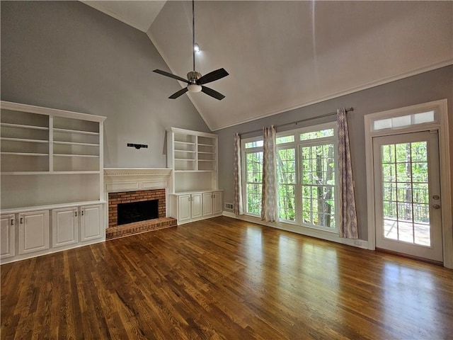 unfurnished living room with high vaulted ceiling, a ceiling fan, baseboards, dark wood-style flooring, and a brick fireplace