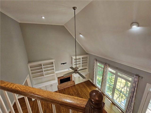 living area featuring stairway, dark wood-style floors, vaulted ceiling, crown molding, and baseboards