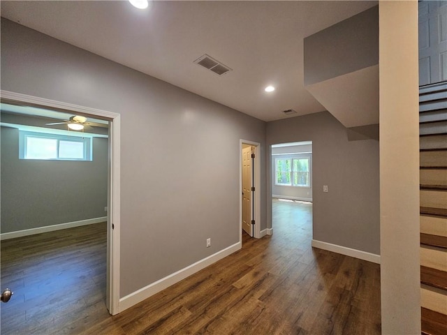 unfurnished room with recessed lighting, visible vents, baseboards, and dark wood-style flooring