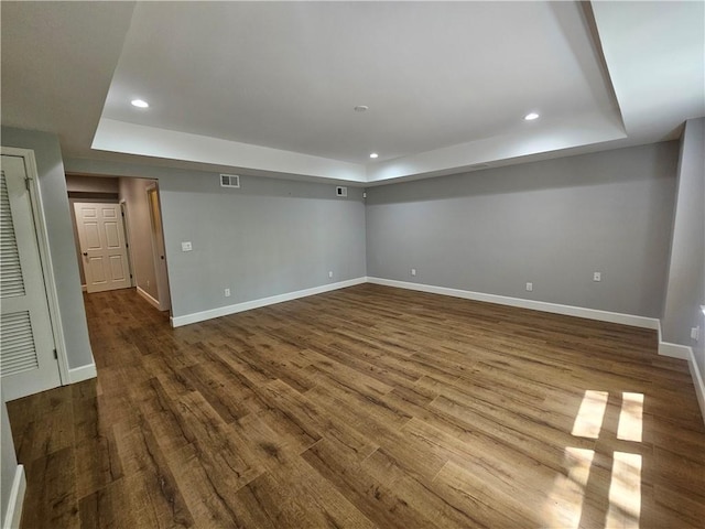 basement featuring recessed lighting, visible vents, baseboards, and dark wood-style flooring