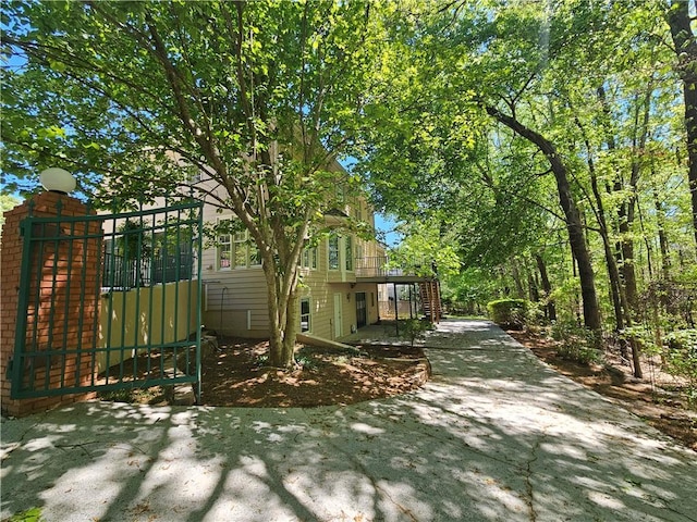 view of home's exterior with a gate and stairs