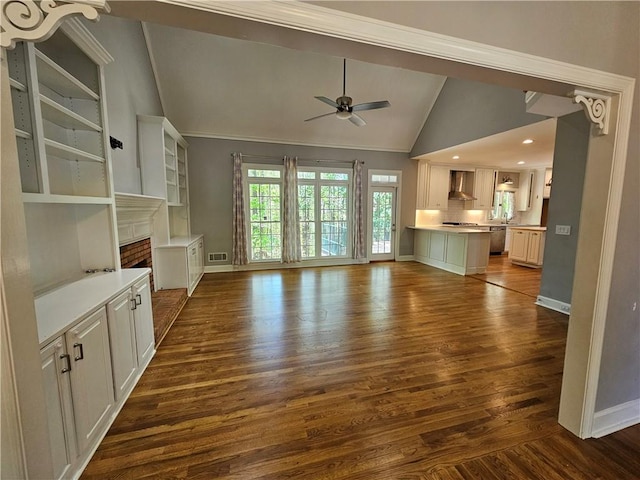unfurnished living room featuring vaulted ceiling, a ceiling fan, a fireplace, baseboards, and dark wood-style flooring