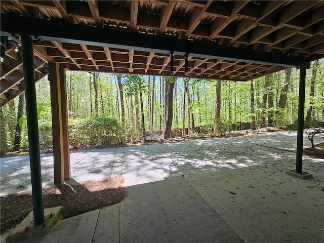 view of patio / terrace with a forest view