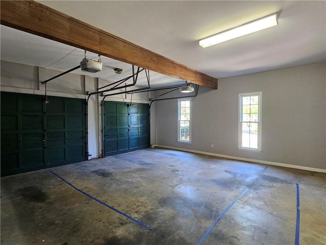 garage with a garage door opener and baseboards