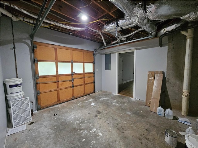 below grade area with electric panel and a garage