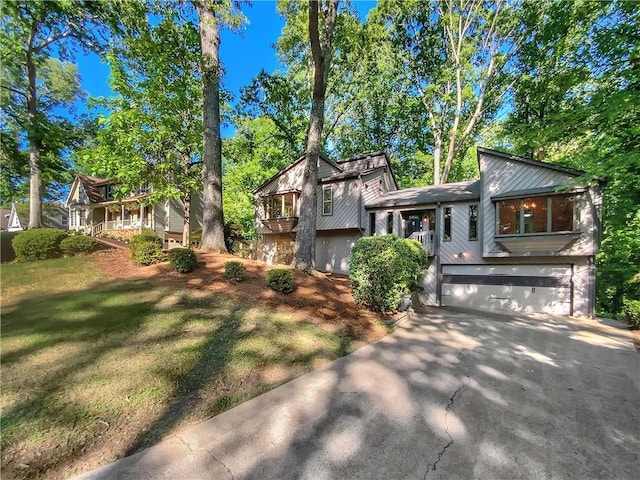 split level home featuring a garage and a front lawn