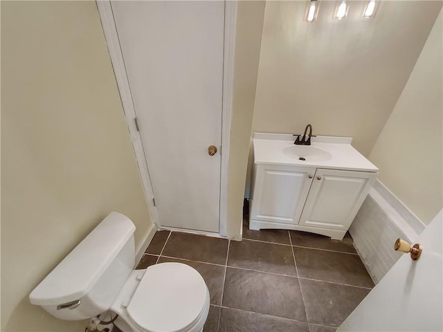 bathroom featuring tile patterned flooring, vanity, and toilet