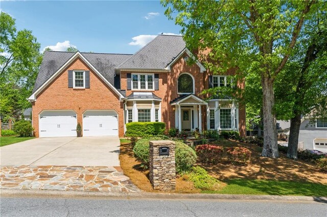 579 Delphinium Blvd NW, Acworth, GA 30102 - view of front of property with an attached garage, brick siding, and concrete driveway