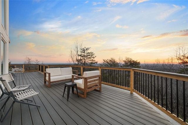 deck at dusk featuring an outdoor hangout area