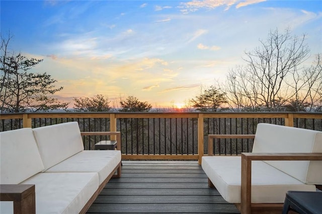 deck at dusk featuring an outdoor hangout area