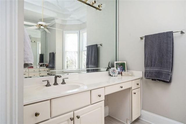 bathroom featuring ceiling fan, baseboards, vanity, and crown molding