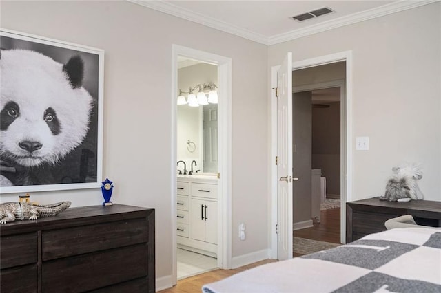 bedroom with baseboards, visible vents, ornamental molding, ensuite bathroom, and light wood-style floors