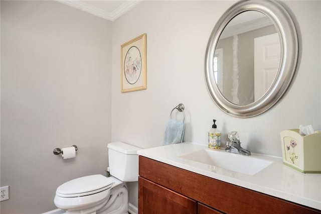 bathroom with vanity, toilet, and crown molding