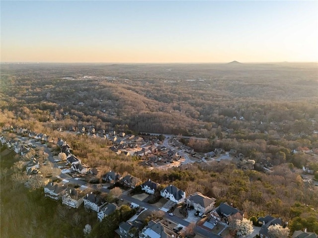 aerial view at dusk featuring a residential view