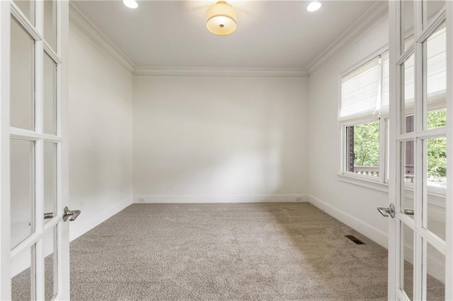 unfurnished room featuring french doors, carpet flooring, ornamental molding, baseboards, and recessed lighting