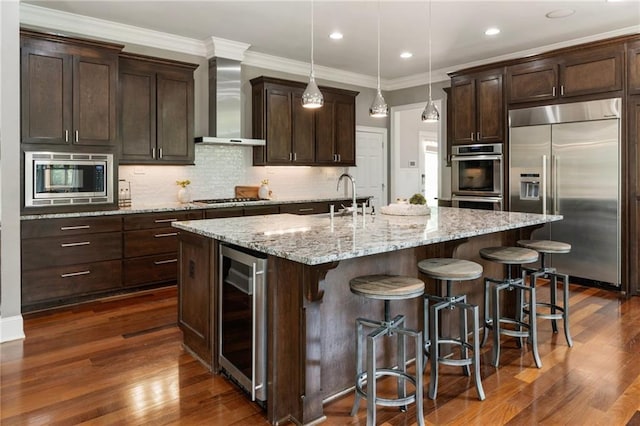 16720 Quayside Dr, Alpharetta, GA 30004 - kitchen featuring built in appliances, wine cooler, wall chimney exhaust hood, a sink, and dark brown cabinets