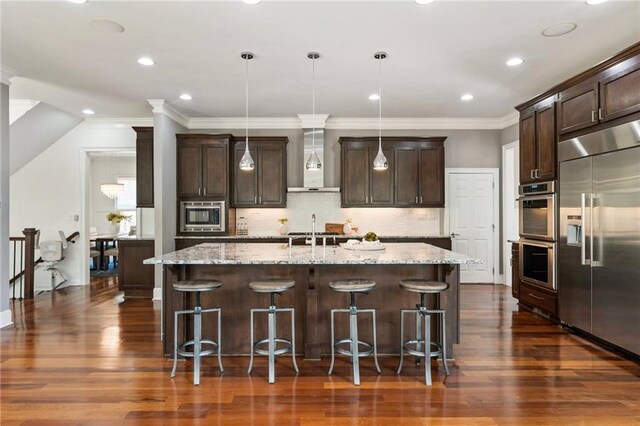 16720 Quayside Dr, Alpharetta, GA 30004 - kitchen with built in appliances, a sink, wall chimney range hood, dark brown cabinets, and ornamental molding