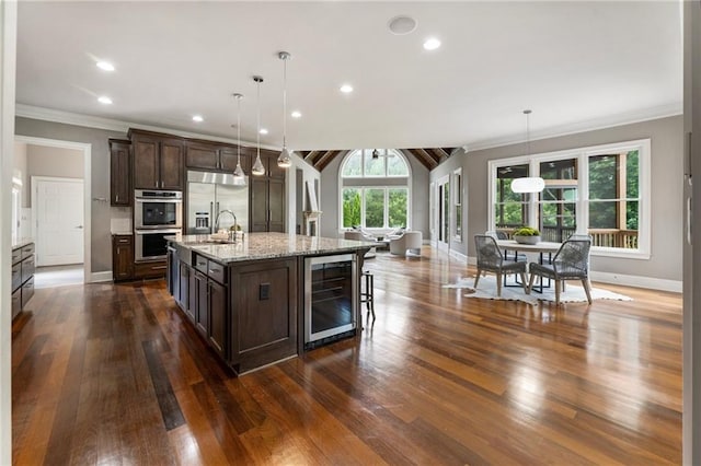 16720 Quayside Dr, Alpharetta, GA 30004 - kitchen with stainless steel appliances, wine cooler, a sink, baseboards, and dark brown cabinets