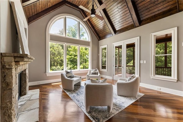16720 Quayside Dr, Alpharetta, GA 30004 - living area featuring plenty of natural light, wooden ceiling with exposed beams, a ceiling fan, baseboards, and a fireplace